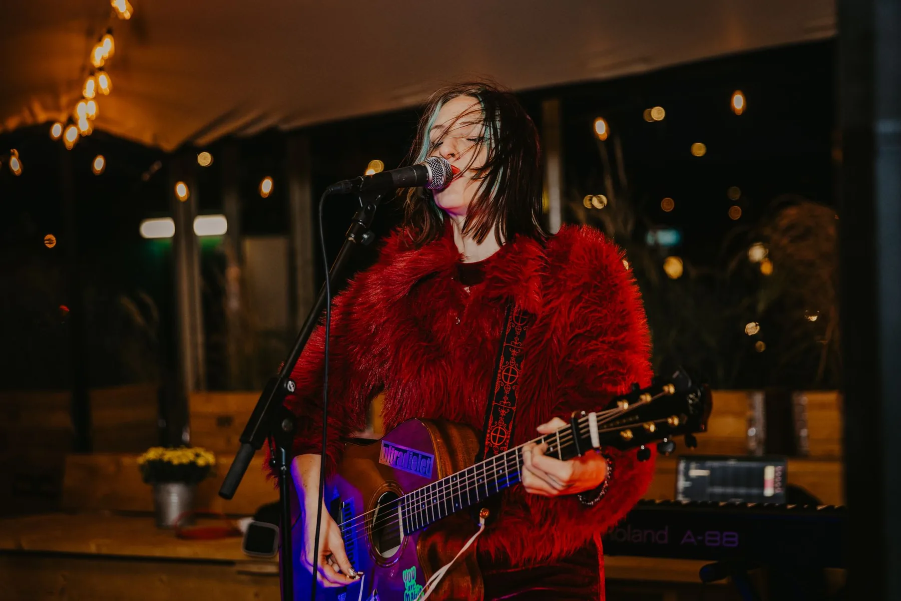 Live singer at a microphone in concert Live singer at a microphone in concert