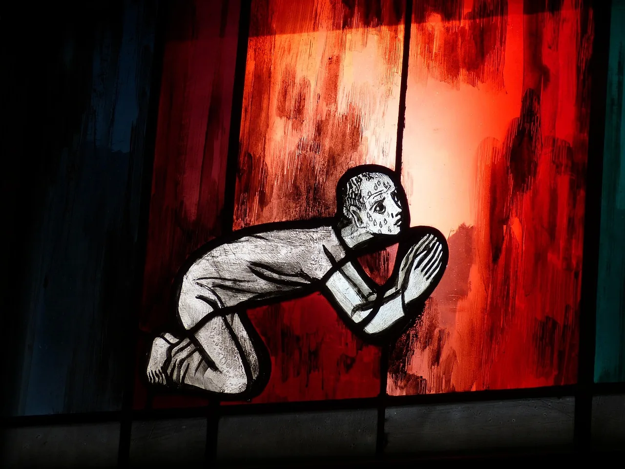 religious stained-glass window in silent prayer