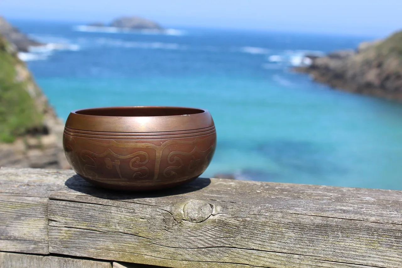 engraved Tibetan singing bowl facing the sea