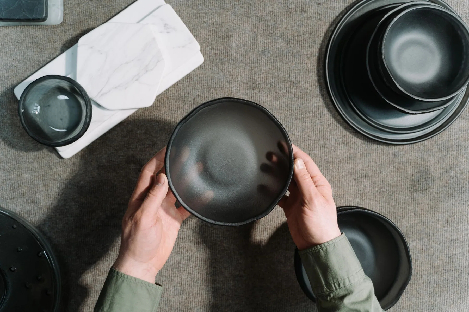 hands examining an artisanal bowl hands examining an artisanal bowl