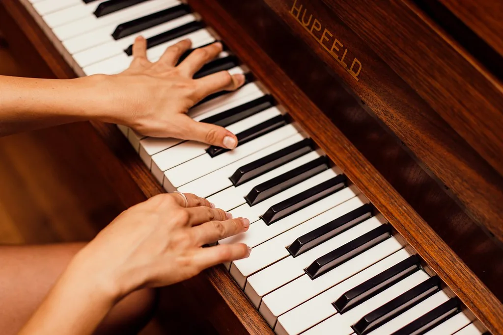 pianist testing an upright piano pianist testing an upright piano